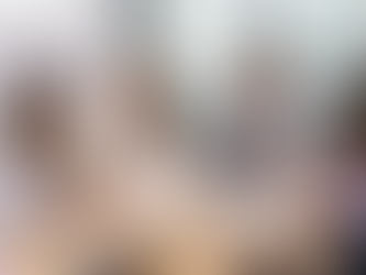 Ein Projektteam sitzt zusammen am Tisch. Eine Frau, die Auftraggeberin, brieft das Team für einen Teamevent.