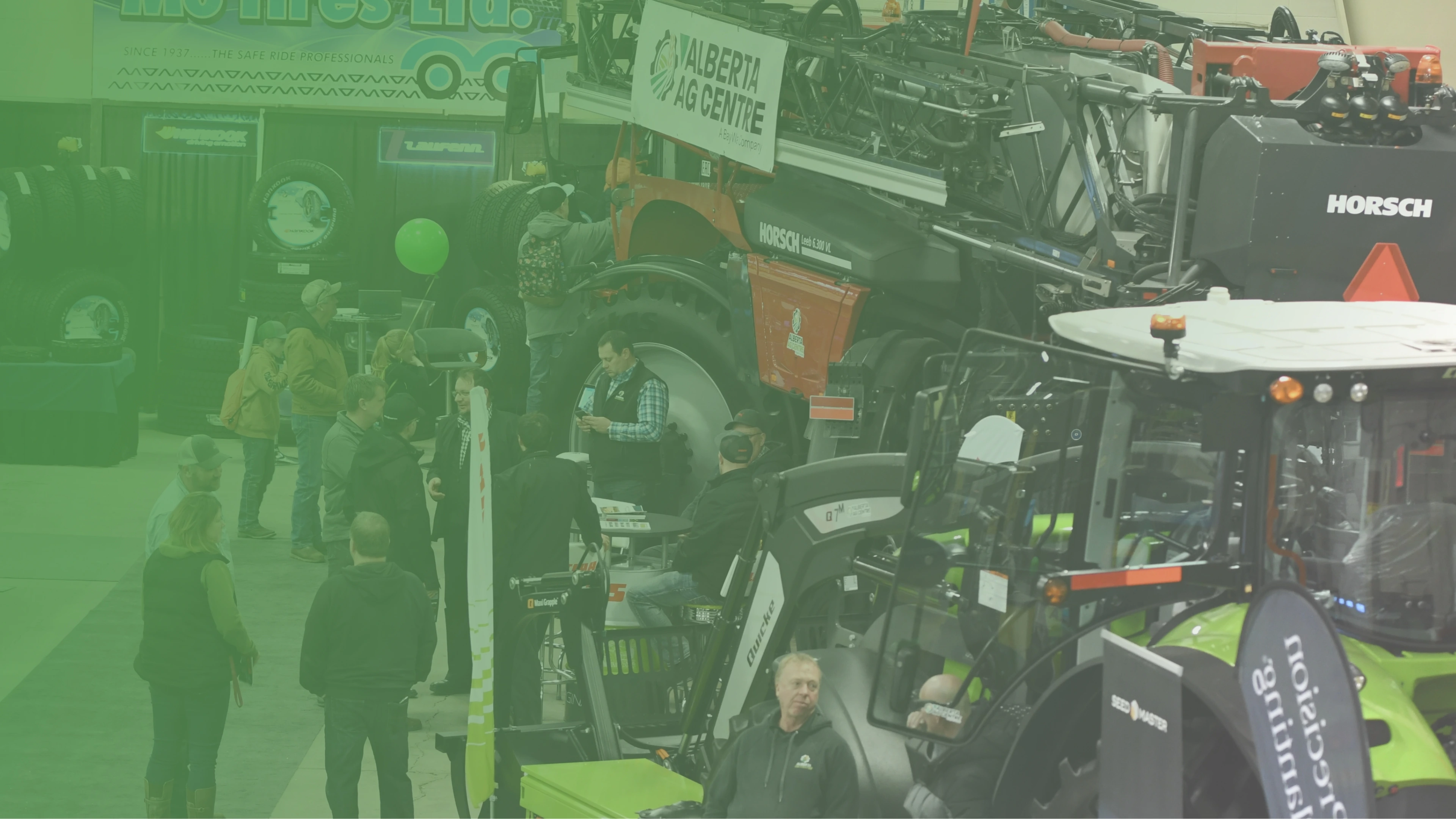 people and farm equipment at agriculture trade show