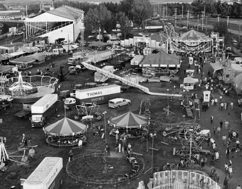 old black and white image of rides at fairground at Lethbridge and district exhibition grounds