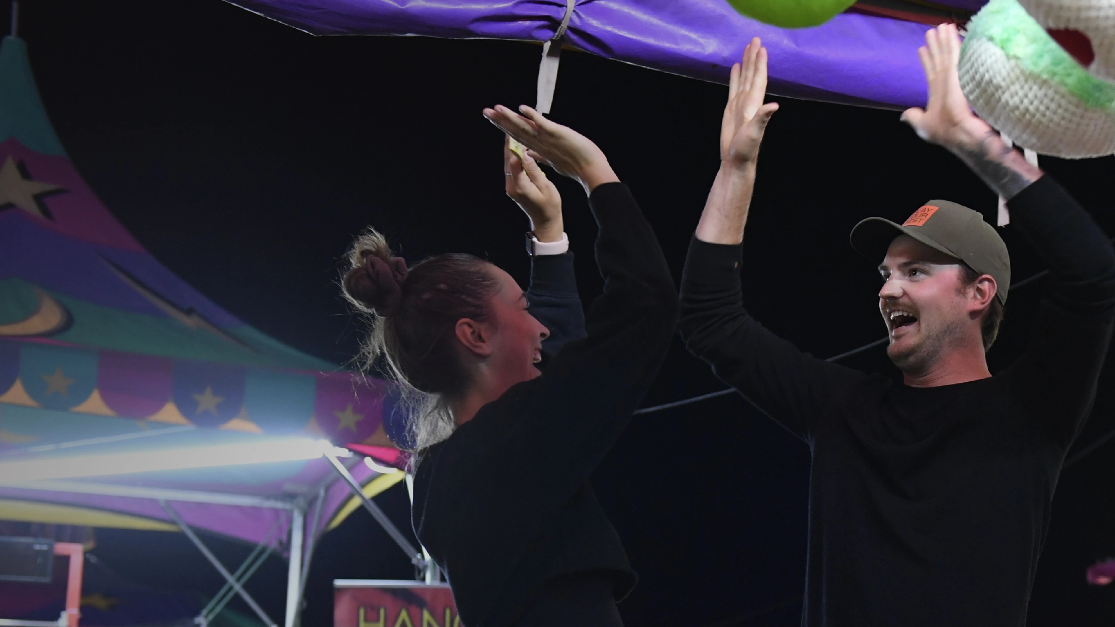 2 people high fiving at a fair