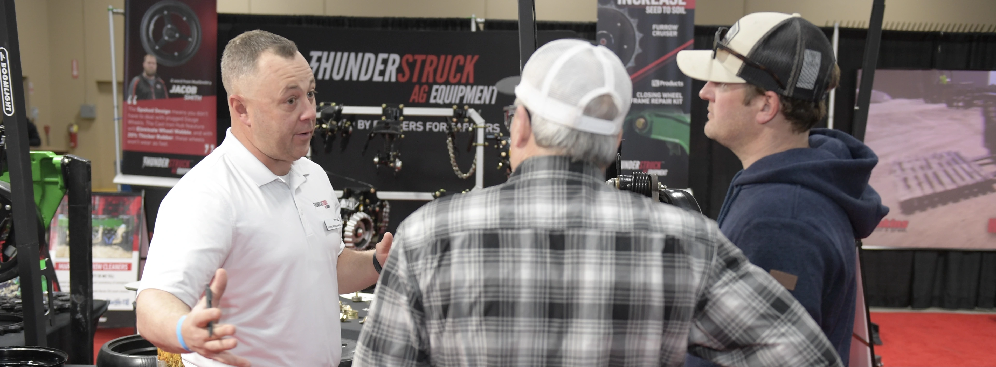 3 men talking at trade show