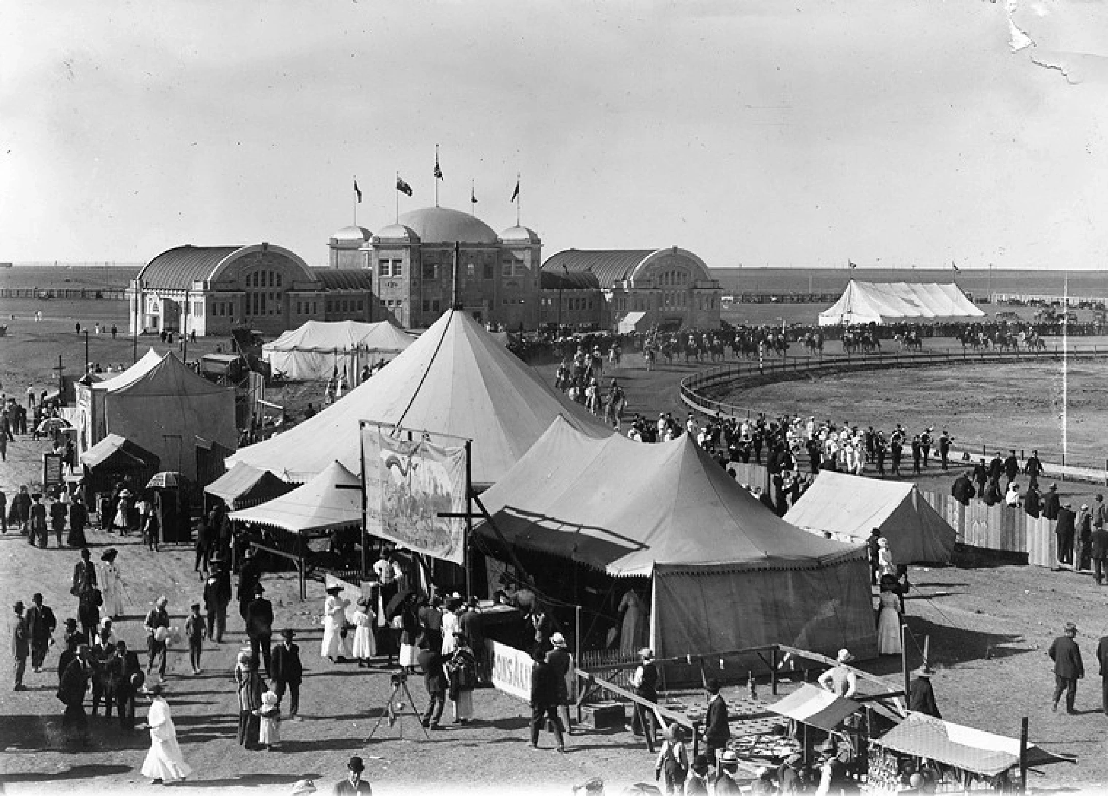 old black and white image of people at fairgrouind and horse races at Lethbridge and district exhibition grounds