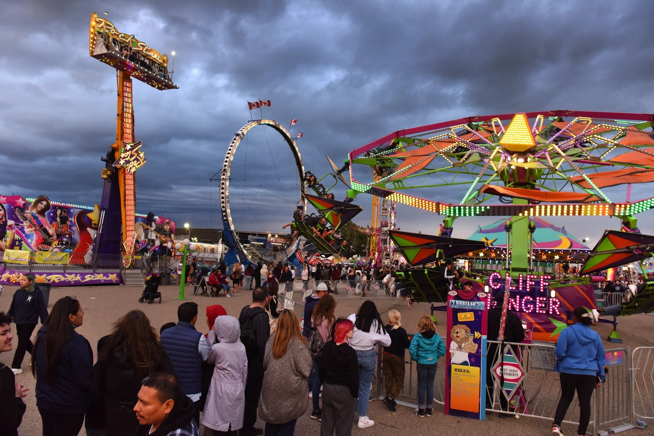 Fair grounds with rides and crowds of people