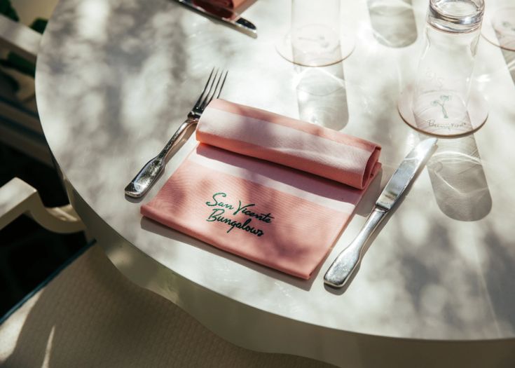 A pink personalised and branded napkin with embroidery