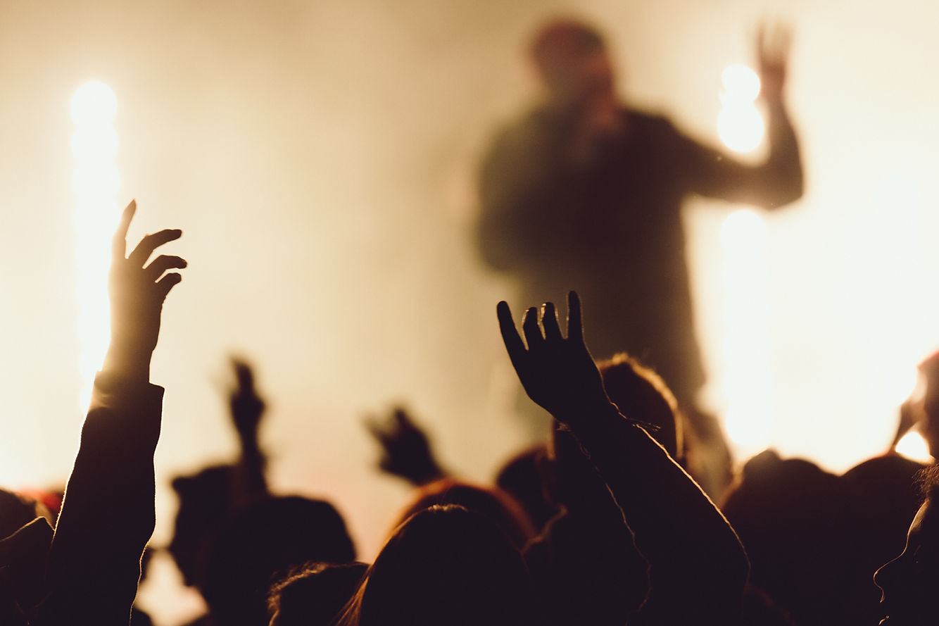 dancing-concert-while-singer-is-performing-surrounded-with-lights.jpg