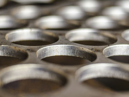 Close up image of holes on stainless steel plate made by plasma cutting machine_edited.jpg