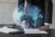 Businessman in suit signs contract. Double exposure with world map hologram. Man signing a