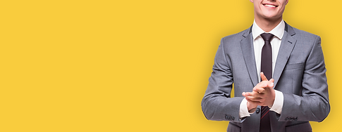 happy-business-man-wearing-grey-suit-standing-isolated-white-wall.png