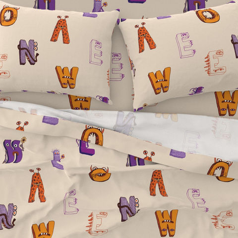 image of kids sheets and pillowcases showing cream monster letters design