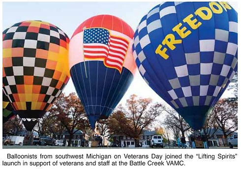 Three hot air balloons, one with American flag, at Veterans Day launch