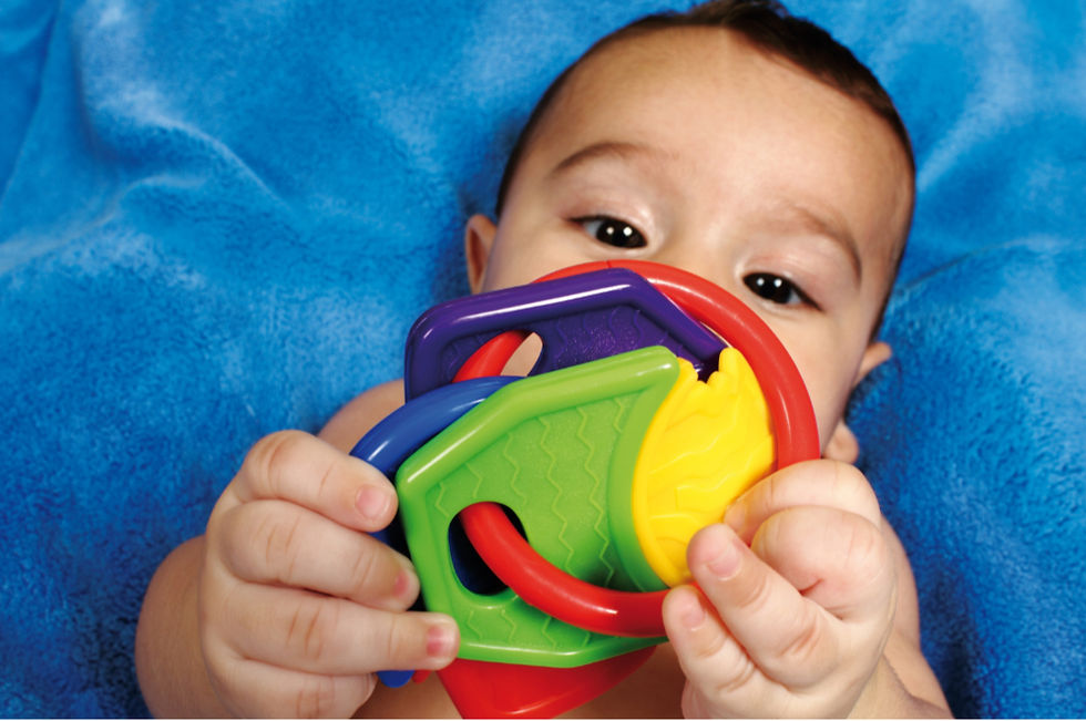 Baby playing with a colourful toy