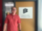 CEO John Samuelson in front of Suite door