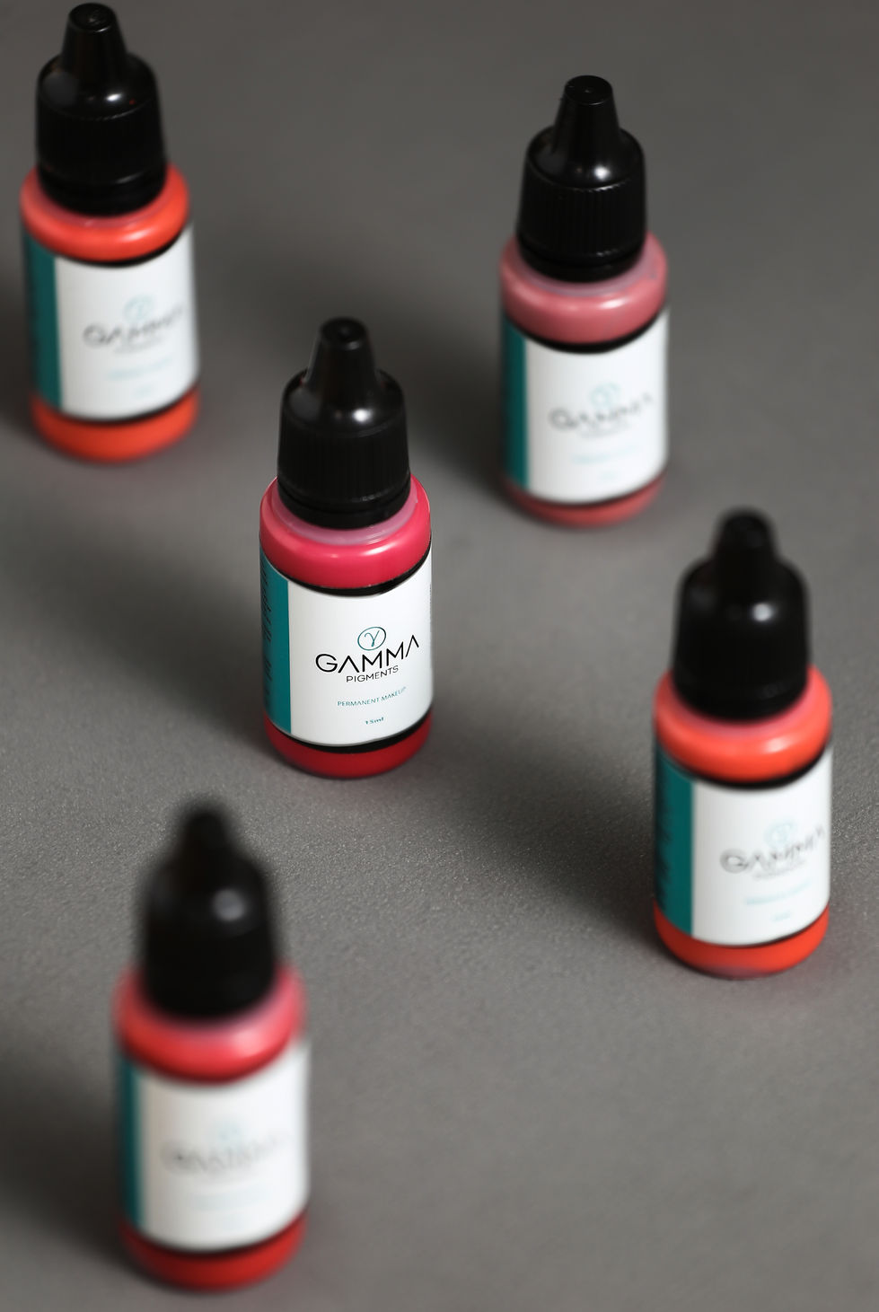 several bottles of gamma pigments are sitting on a table, tailor made by Rafael Fazano