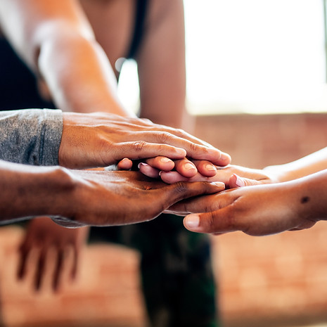 Diverse group of people, putting hands together in a team huddle Diverse group, teamwork,