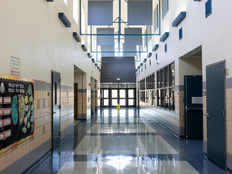 Professional contract security guard monitoring a school entrance