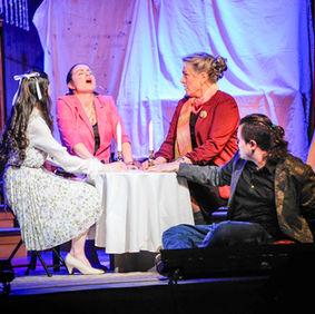 Cast members in a seance during the play I Hate Hamlet.