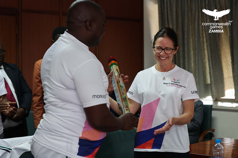 Commonwealth Games Association of Zambia President Alfred Foloko handing the King's Baton Relay to the British High Commissioner to Zambia H.E Rebecca Terzeon