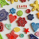 Colourful ceramic shapes made by Dottery Pottery.  Flowers, birds, stars, hearts, leaves and more