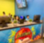 Children play at computer stations at the library