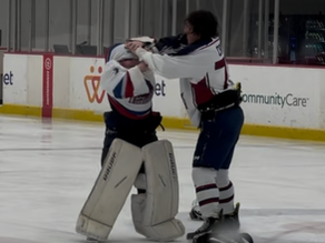 Youth hockey goalie in full gear grapples with another player during a humorous on-ice scuffle, illustrating the importance of teaching safe and legal body contact to build confidence and avoid improper physical play.