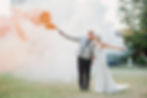 Bride and groom with smoke flares at Mottram Hall
