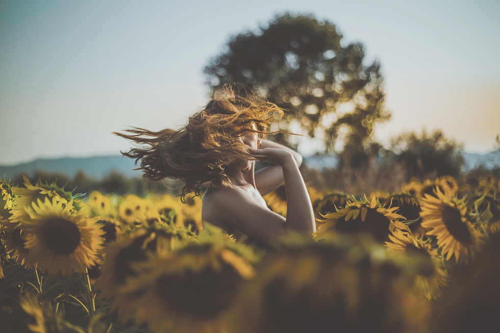 Matteo Vistocco via Unsplash woman in sunflower field