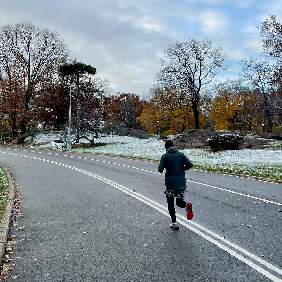 Man running outdoors at a park in the city of Chicago in the winter.