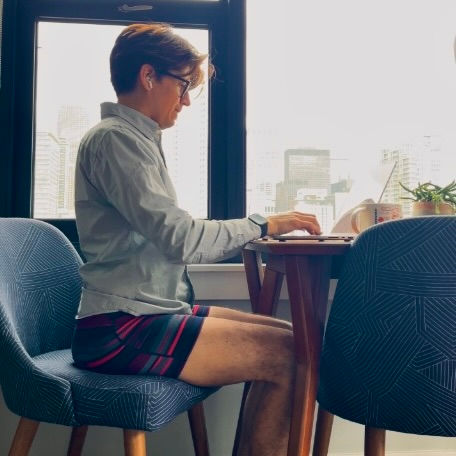 Man sitting in a chair in their Saxx Underwear while working from home