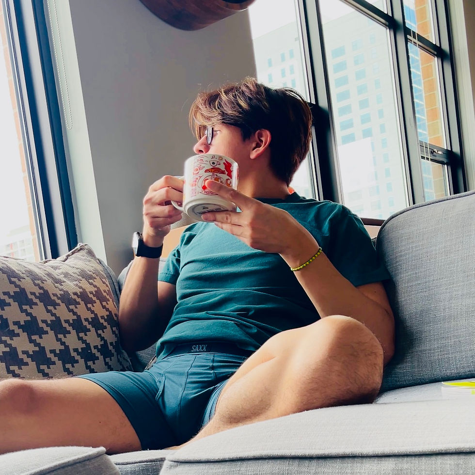 Man drinking coffee in their saxx underwear at home