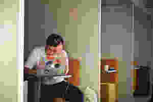 Frustrated man working on a laptop hoping he can delegate some of his work