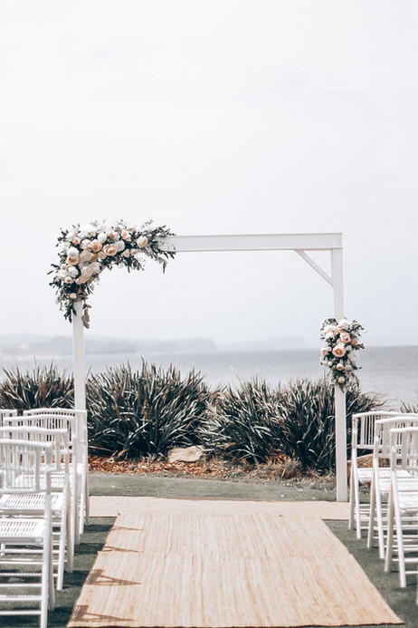pretty pastel flowers on wedding arch at long reef