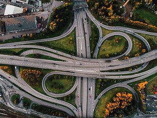 aerial-shot-twisted-roads-surrounded-by-parks-middle-city.jpg