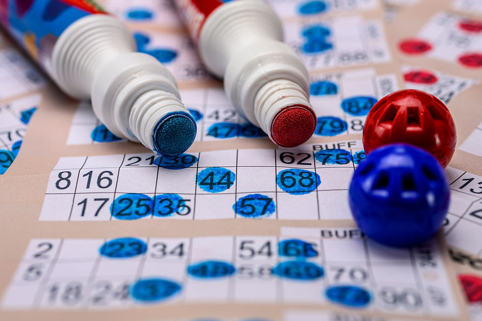 Close-up of colorful bingo cards with red and blue markers