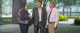 Three business colleagues conversing outdoors