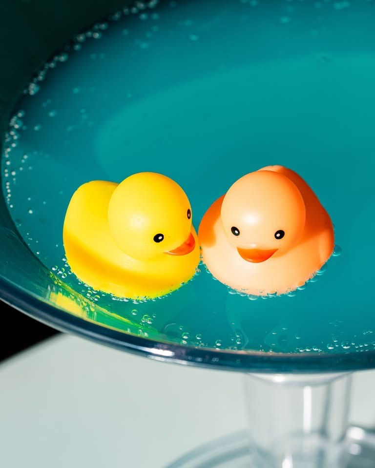 Blue cocktail with floating rubber ducks, served at Rendezvous Pub in Langley.