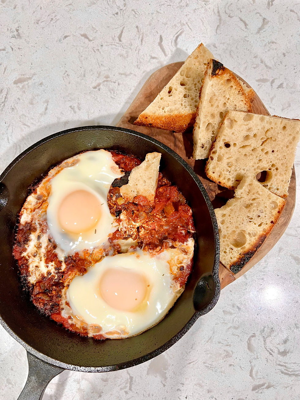 eggs in a tomato sauce served with sourdough toast