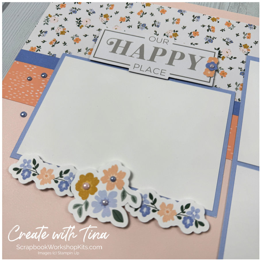 Bloom Boutique scrapbook page with Our Happy Place title, blue photo mat, floral ephemera and In Color Dots.