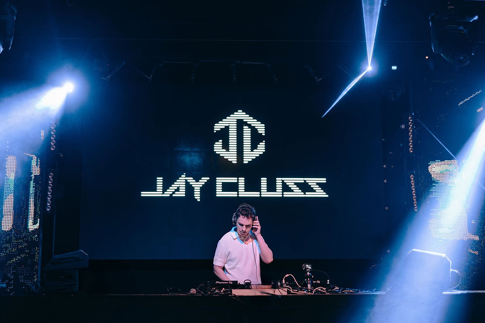 Wide-angle view of a dim dance floor with soft blue lights and a DJ mixer in the foreground