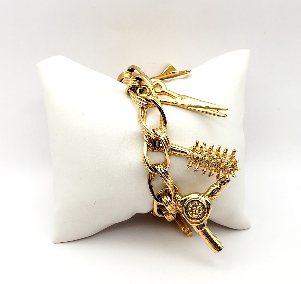 Thumbnail: gold tone hair stylist charm bracelet with styling tool charms