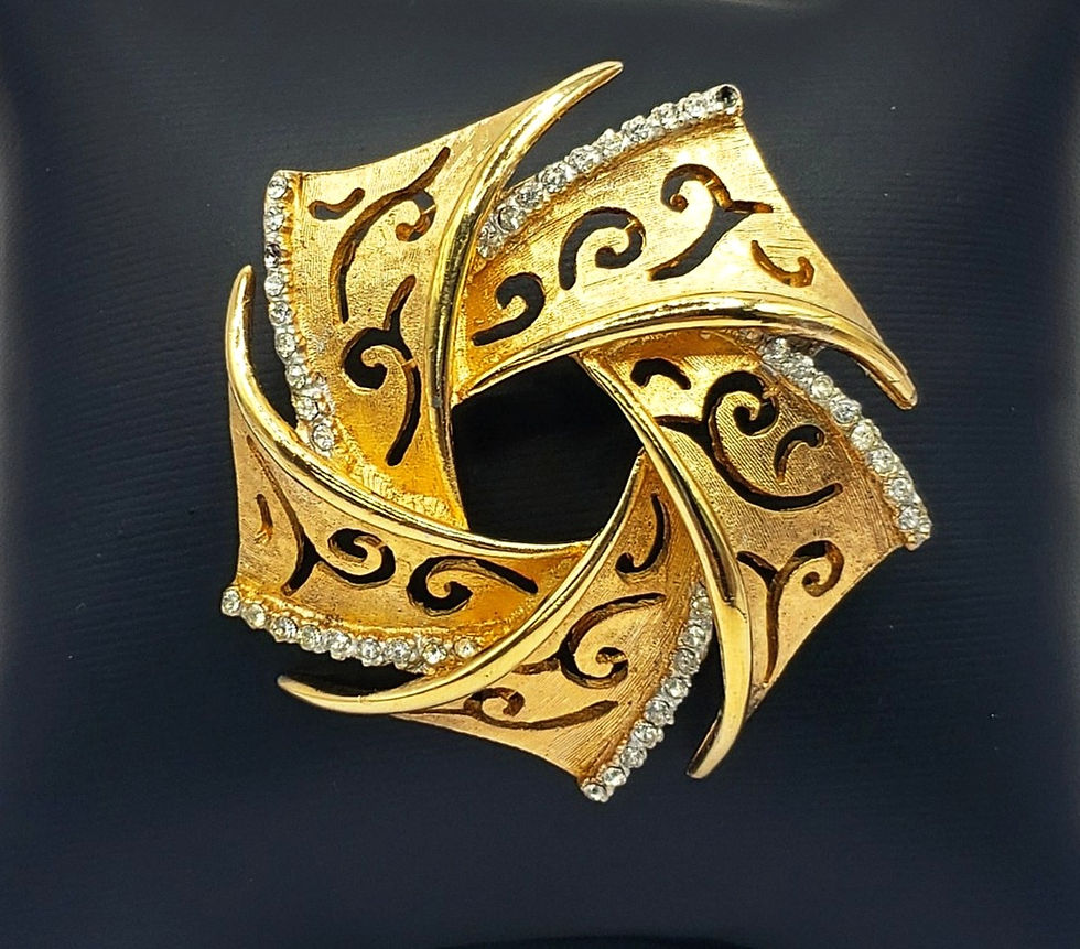 Vintage BSK Gold Tone & Rhinestone Swirl Brooch close up view
