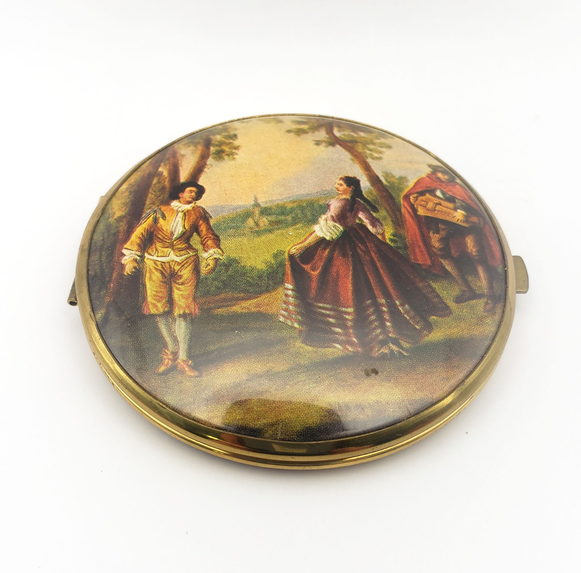 vintage compact with courting couple scene on cover