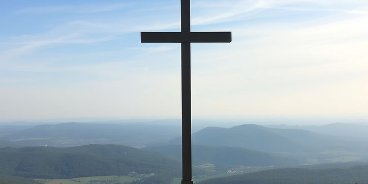 a cross up on a hilltop with the valley in front.jpg