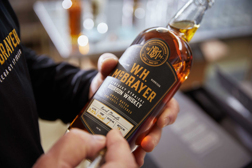 W.H. McBrayer Bourbon bottle being signed