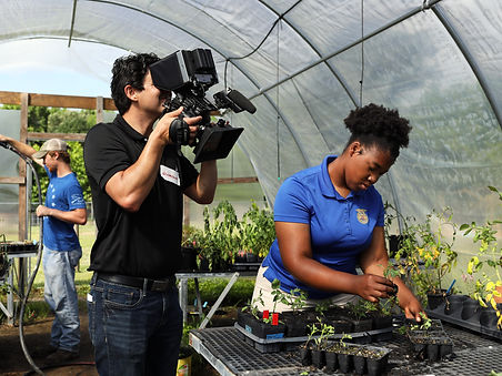 Filming with Canon Camera handheld a student named Jayla at her school Lowcountry Leadership Charter Schoolin the Greenhouse planting seeds