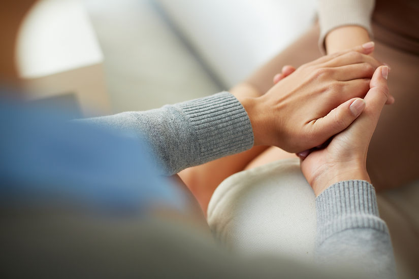 Close-up of psychiatrist hands together holding palm of her patient.jpg
