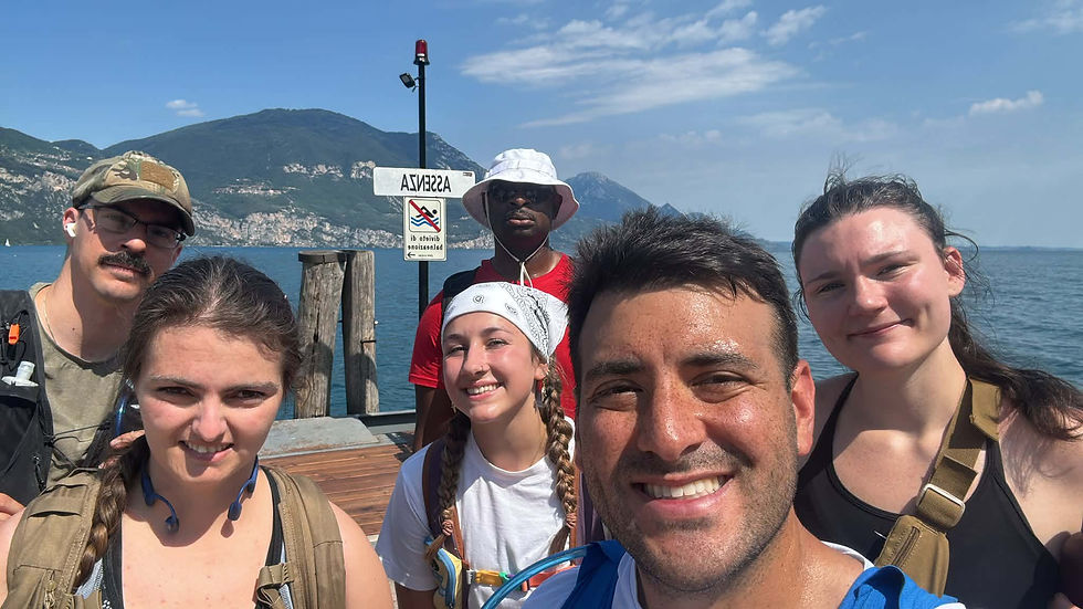 A selfie of the six service members during the march, with Lake Garda's beautiful scenery behind them.