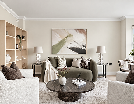 Living room staged with rental furniture: a curved green sofa, boucle armchairs and a marble coffee table