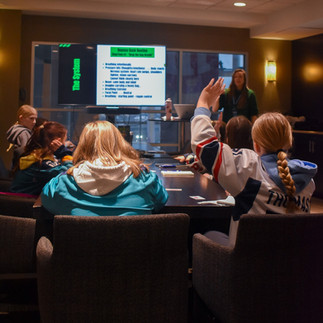 Player asking a question during women's hockey workshop on mental conditioning