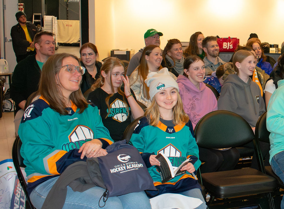 Parent and girl hockey player sitting through GWHA nutrition workshop