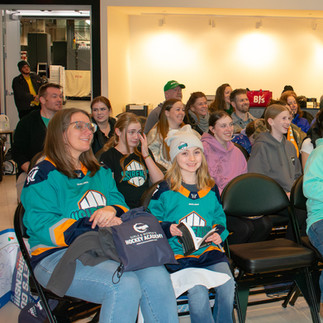 Young hockey player and her parent at Girls & Women's Hockey Academy event